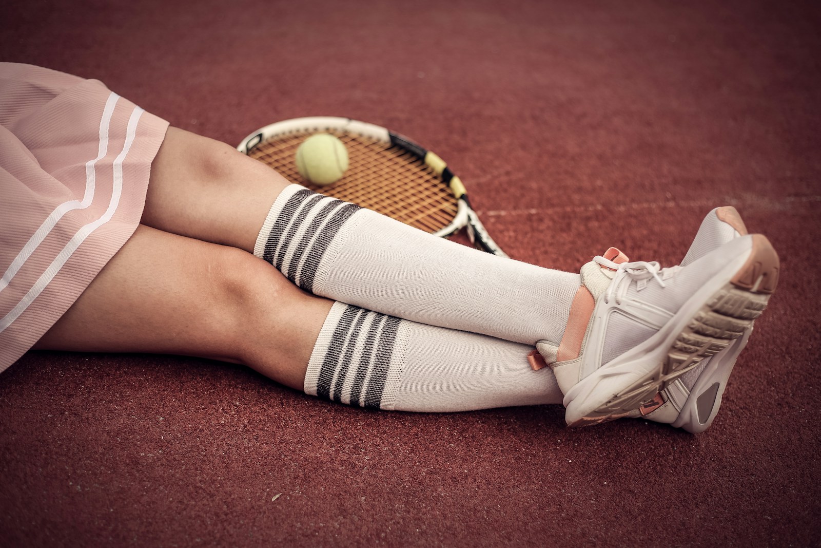 person wearing white low top sneakers