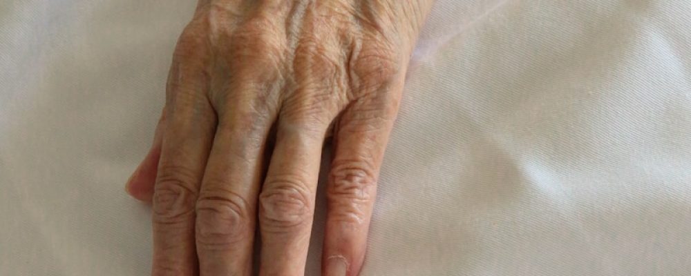 persons left hand on white textile